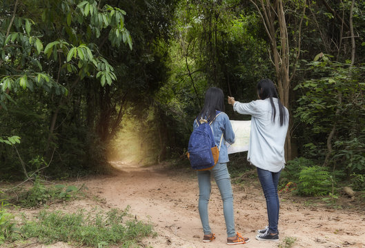 Girl frienship traveling in the woods, Map in hand, and get dire
