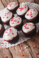 Freshly red velvet cupcakes close-up on the table. vertical
