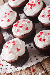 red velvet cupcakes on a lacy napkin close-up. vertical