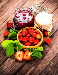 Strawberry on wood background. Strawberry with green leaves flow