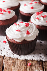 red velvet cupcakes decorated with hearts close-up. vertical