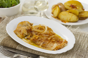 cod fish with potato on white dish