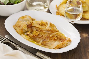 cod fish with potato on white dish