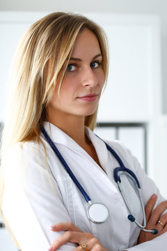 Beautiful female doctor with hands crossed on chest