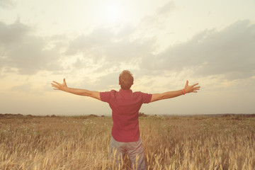 Man enjoying in nature. Wheat field.
