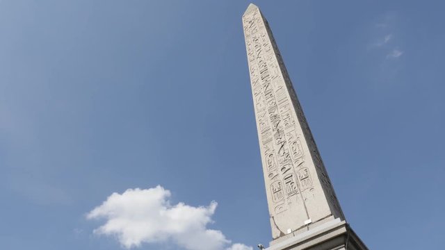 French symbol on Place de la Concorde Luxor Obelisk with Egyptian hieroglyphs in front of blues sky 