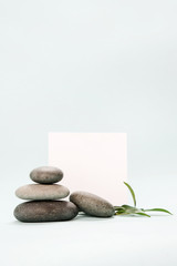 Blank paper surrounded by balanced spa stones