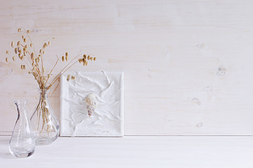 Soft home decor. Seashells and glass vase with spikelets   on  white wood background. Interior.