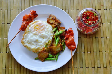 spicy stir fried crispy pork curry with egg and chili fish sauce
