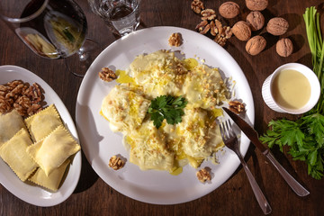 Classic ravioli with nuts and sauce, glass of Italian wine.