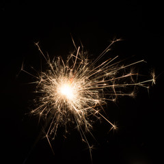 Burning sparkler isolated on black background