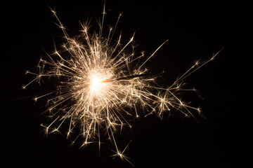 Burning sparkler isolated on black background