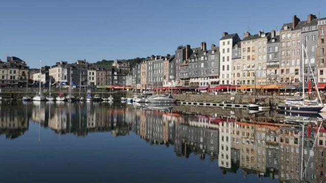 Colorful facades water reflection of famous northern Normandy artistic place and port by the day slow panning footage 