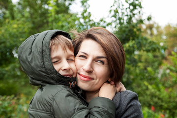 Mother and son hugging in park