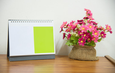  flowers with coffee cup on workspace.