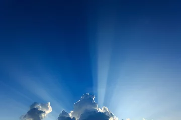 Papier Peint photo Ciel light rays explosion on clear blue sky with cloud