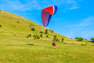 
Paraglider over the green valley
