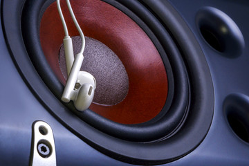 headphones on the background of audio speaker. Musical equipment. Close up