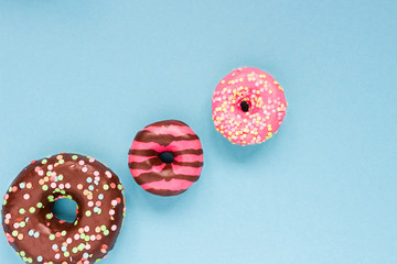 Sweet donuts on the blue background.