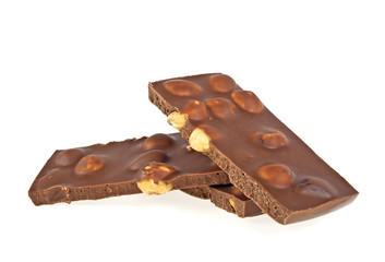 Milk chocolate bar with nuts on a white background, closeup