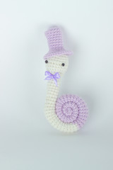 soft toy crochet in the form of a snail in a cap