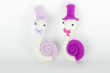 soft toy crochet in the form of a snail in a cap