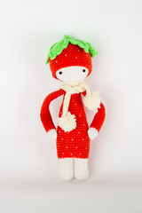 soft toy crochet a red strawberry in a white cap and scarf
