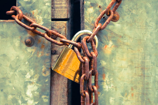 Closed Up Key Lock With A Chain On An Old Wooden Metal Door