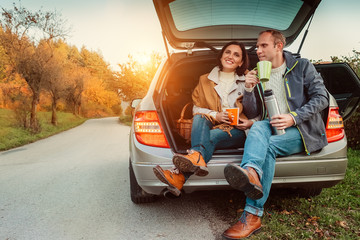 Couple have a tea break on their auto travel