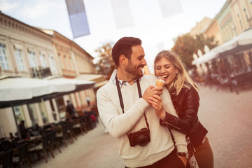 Couple sharing ice cream outdoors