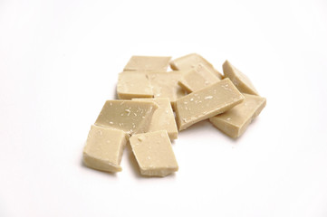 pieces of white chocolate on white background