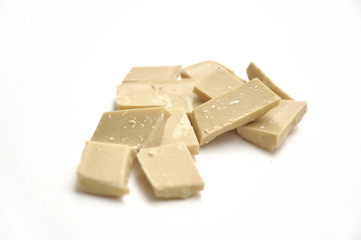 pieces of white chocolate on white background