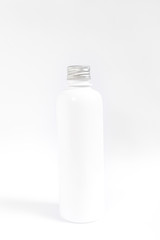 close up of a white bottle on white background 