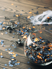 Fototapeta premium Halloween party confetti on dark background. Vertical