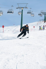 Ski man black dress downhill mountain ski lift snow race fast run