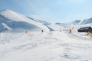 Fototapeta na wymiar Ski run slope downhill wide broad mountain snow