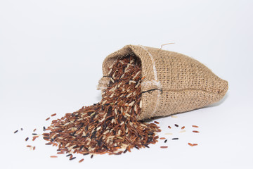 brown rice in jute bag ion white