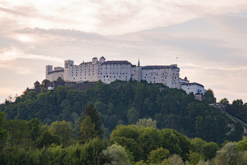 Fototapeta na wymiar Salzburg castle fortress Hohensalzburg on a hill, sunrise sunset