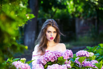 pretty girl in hydrangea flowers