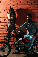 Naklejka na ściany i meble bearded biker man on motorbike
