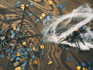 Halloween confetti and spiders on dark background