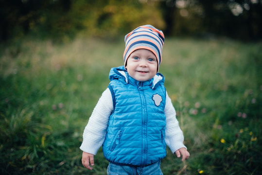 little boy in blue in the autumn park