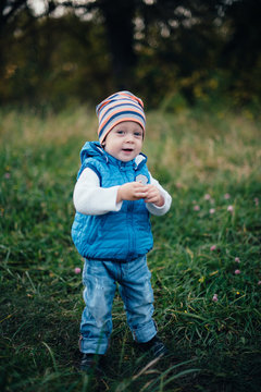 little boy in blue in the autumn park