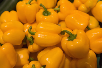 Several pods of orange sweet pepper, capsicum. Orange pepper background