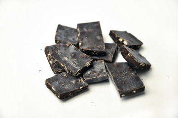 dark chocolate pieces on white background