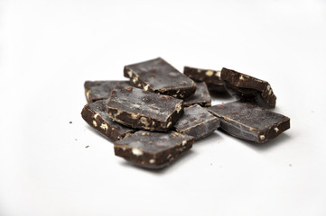 dark chocolate pieces on white background