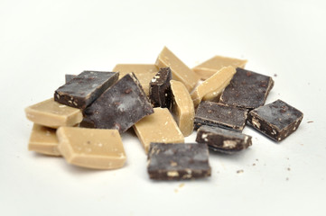 dark and white chocolate pieces on white background
