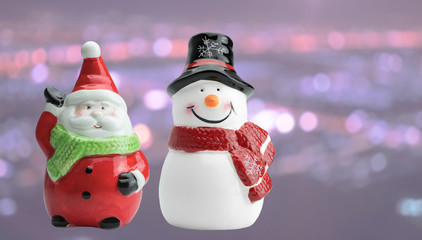 Ceramic Santa Clause and snowman model on bokeh background