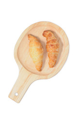 Double croissants on wooden plate