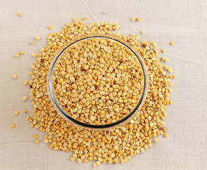 Toor dal, also known as split pigeon pea, rich in proteins, in a glass bowl.